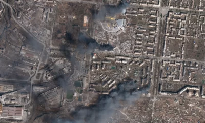 In this satellite photo from Planet Labs PBC, multiple civilian buildings burn amid Russian strikes on the Livoberezhnyi District of Mariupol, Ukraine, Sunday, March 20, 2022.