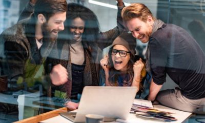 A group of people looking at a computer Description automatically generated