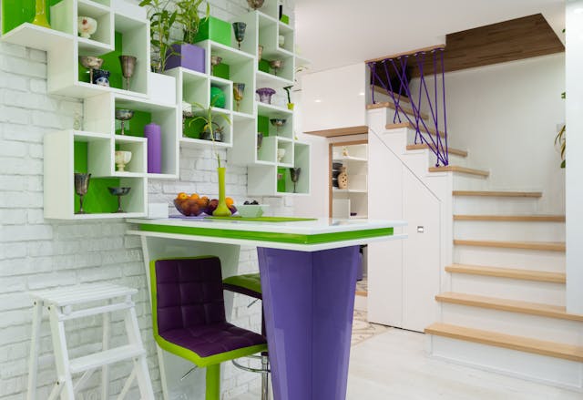 Shelves with different decorations hanging on wall above counter