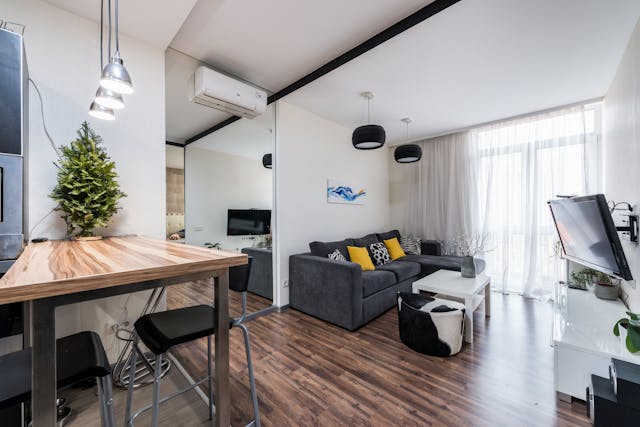 Living room with cozy sofa and wooden counter.