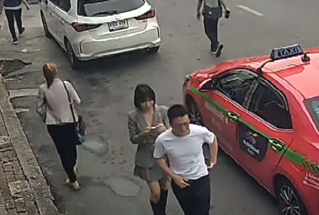 An image from a security camera shows Yan Ruimin checking her phone as she walks in the Sukhumvit area of Bangkok on July 1.